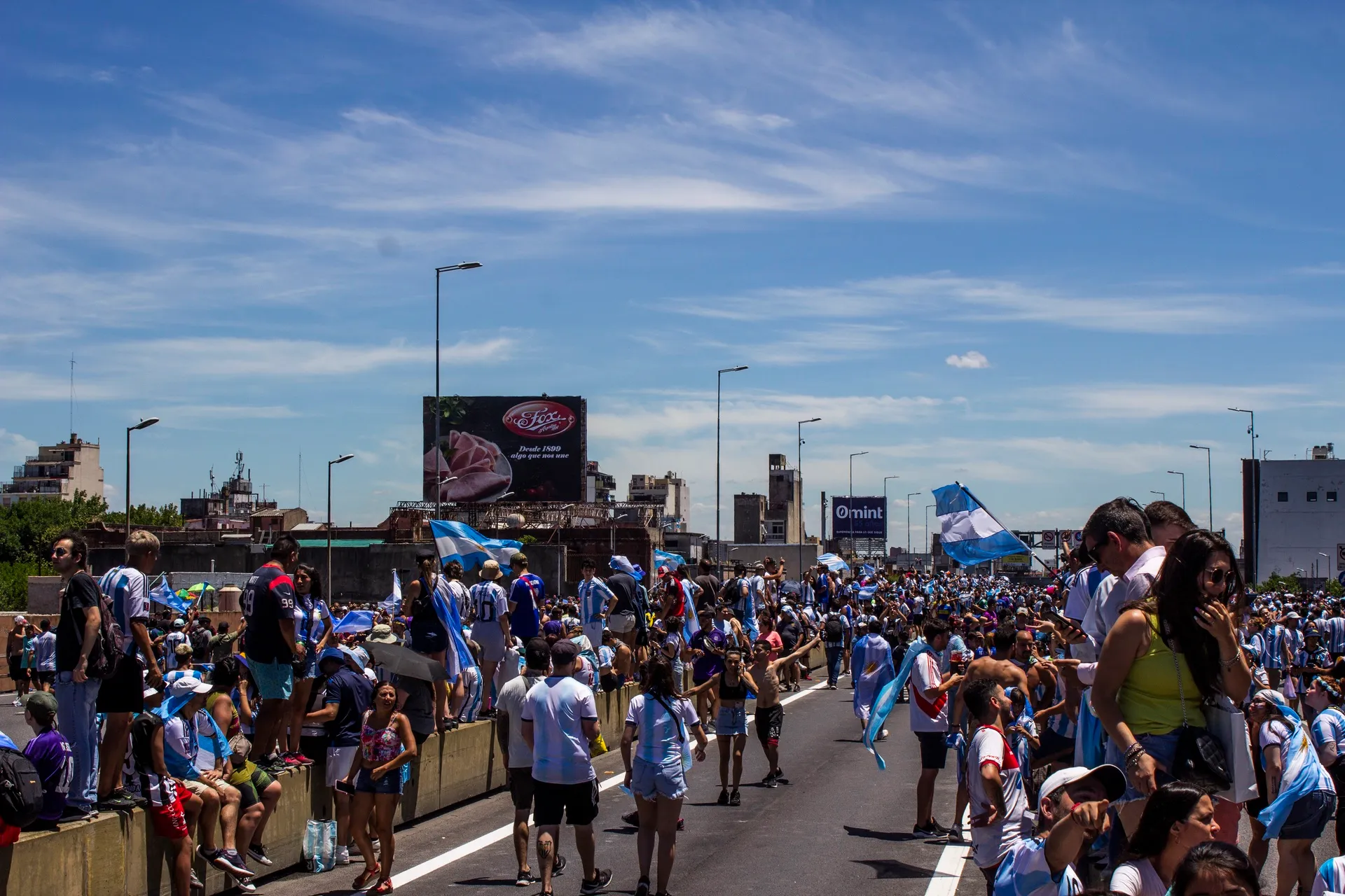 Fans in sky-blue and white flooding a Buenos Aires highway, 2022 World Cup celebrations